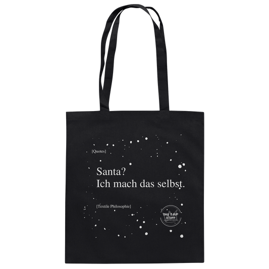 Schwarzer Jutebeutel von „Sag’s auf Stoff“ mit weißer Aufschrift "Santa? Ich mach das selbst.", Weißen Schneeflocken im Hintergrund und Logo "Sag´s auf Stoff". Perfekt als Geschenk.
