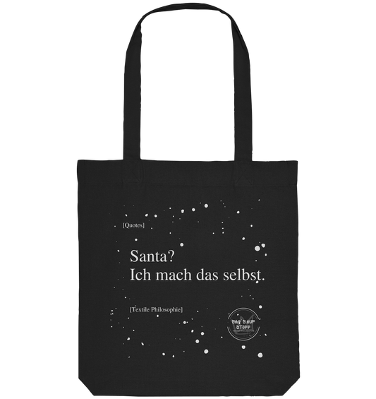 Schwarzer Jutebeutel von „Sag’s auf Stoff“ mit weißer Aufschrift "Santa? Ich mach das selbst.", Weißen Schneeflocken im Hintergrund und Logo "Sag´s auf Stoff". Perfekt als Geschenk.