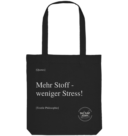 Schwarzer Jutebeutel mit weißer Aufschrift "Mehr Stoff - weniger Stress!" und Logo "Sag´s auf Stoff"